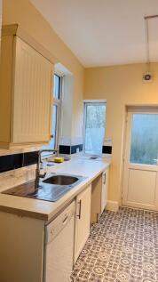 Bright and clean kitchen area with natural ligh...