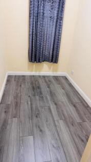A tidy and well-maintained small bedroom with w...