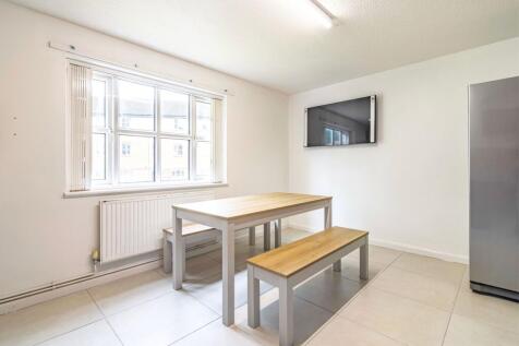 A bright and clean kitchen featuring large wind...