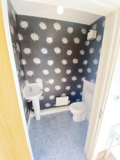 Bright, well-maintained bathroom with patterned...