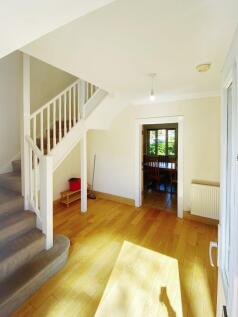 Bright, welcoming entrance hall with warm woode...