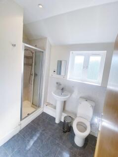 Bright, well-maintained bathroom with a corner ...