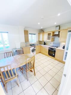 Bright, well-equipped kitchen with natural ligh...