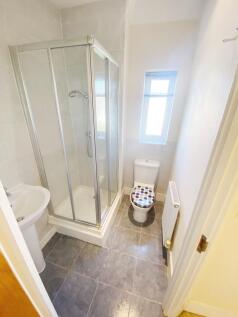 Bright, well-kept bathroom with a corner shower...