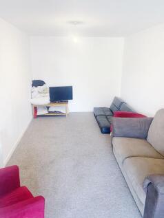 Bright, simply furnished living room with neutr...