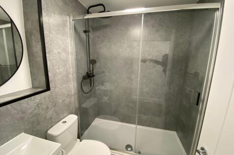 Modern bathroom featuring a spacious shower wit...