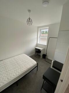 A cozy and well-maintained student bedroom feat...