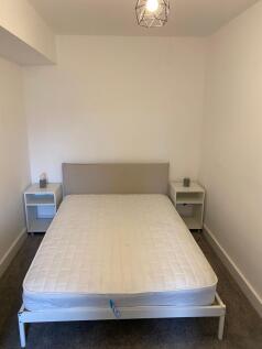 A bright and tidy double bedroom featuring a co...
