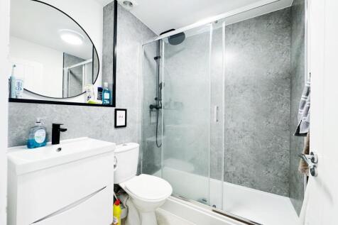 Bright modern bathroom with a walk-in shower an...