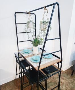 Stylish compact dining nook with a wood tableto...