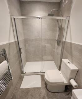 Modern bathroom featuring a large shower enclos...
