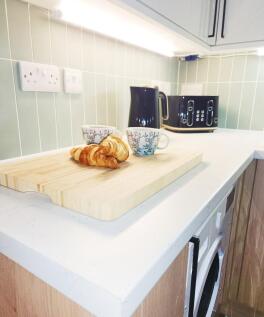 Bright, modern kitchen counter with a clean whi...
