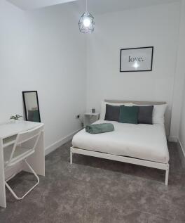 A modern, neatly maintained double bedroom with...