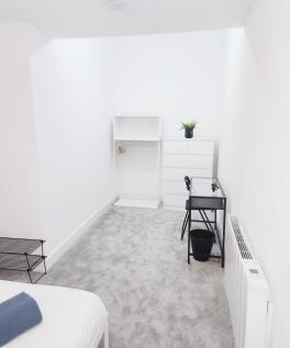 Bright, minimalist single bedroom with neutral ...