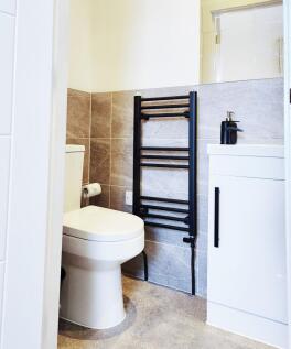 Bright, modern bathroom with a contemporary whi...