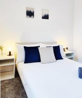 Bright, modern double bedroom with crisp white ...