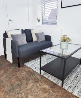 Bright, modern living area with a compact grey ...