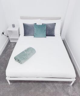 Bright, minimalist double bedroom with a neatly...