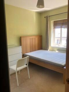 A well-maintained double bedroom featuring a wo...