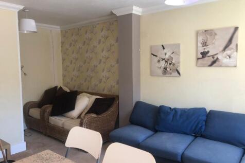 Spacious and well-maintained living room featur...