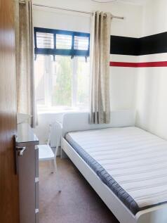 Bright, neatly presented bedroom with a large w...