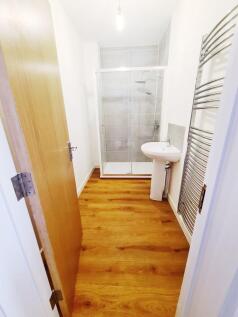 Bright modern bathroom with a walk-in glass sho...