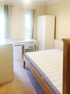 Bright, neatly presented bedroom with a comfort...