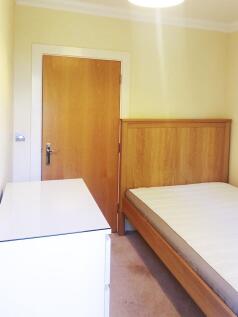 Neat single bedroom with a wooden bed frame and...