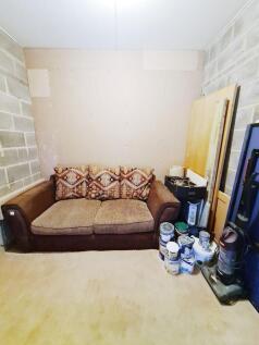 Cozy seating area with a two-seater sofa agains...