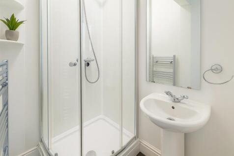 Bright and clean bathroom with a compact shower...