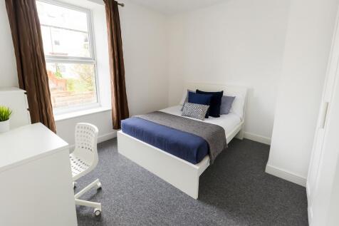 Bright and modern single bedroom featuring a la...