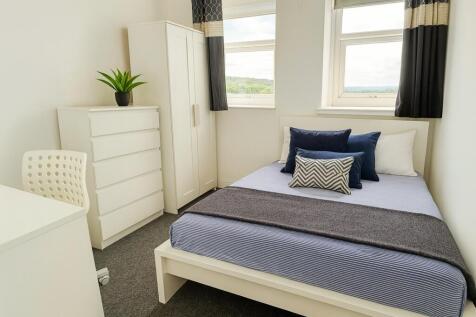 A bright and clean double bedroom featuring a w...