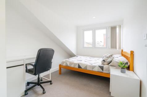 Bright and clean bedroom featuring a comfortabl...
