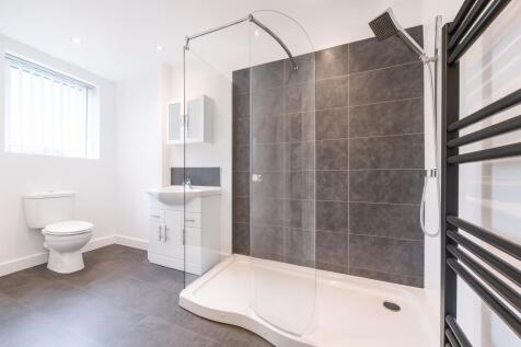 Modern bathroom featuring a spacious shower wit...