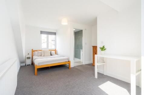 Bright and inviting bedroom featuring a cozy wo...