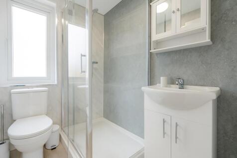 Bright and modern bathroom featuring a clean wh...