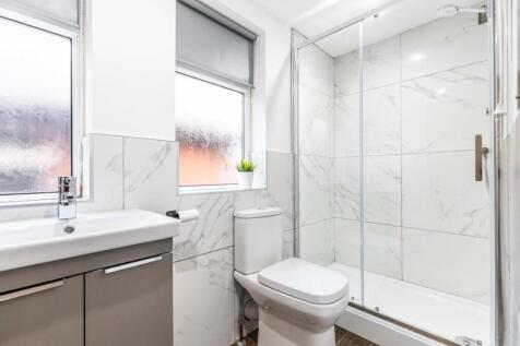 A modern, clean bathroom featuring a spacious s...