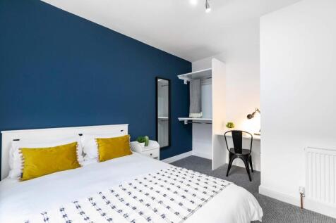 A spacious and well-maintained bedroom featurin...