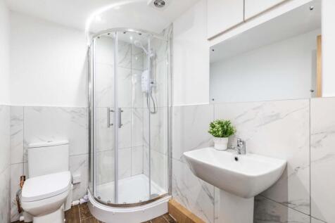 A modern, clean bathroom featuring a spacious s...