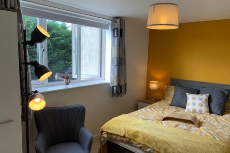 A bright and inviting double bedroom featuring ...