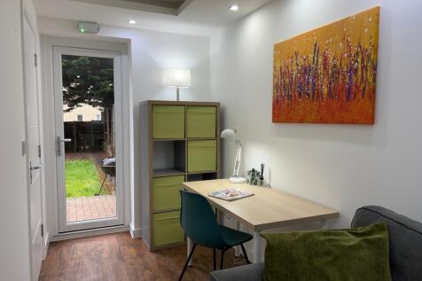 A bright and inviting living room featuring a s...