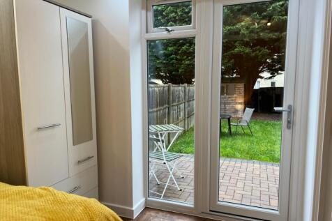 A bright and inviting double bedroom with acces...