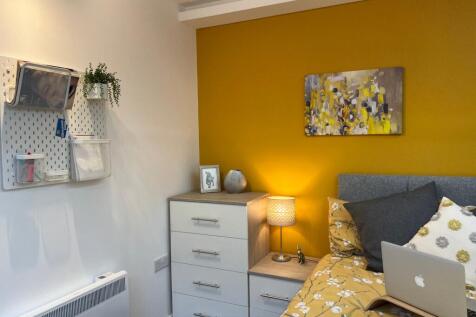 A bright and inviting double bedroom with moder...
