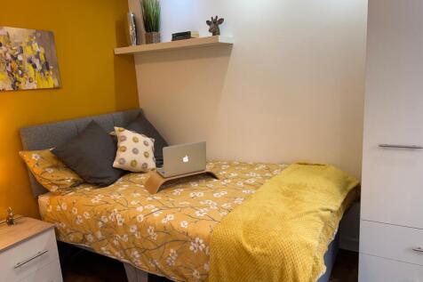 A vibrant and cozy double bedroom featuring war...