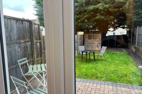 A well-maintained garden area with seating, per...