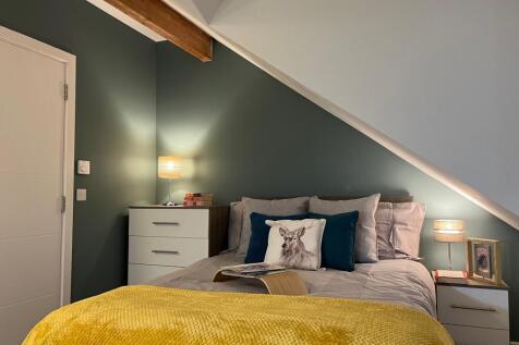 A cozy and inviting double bedroom featuring st...