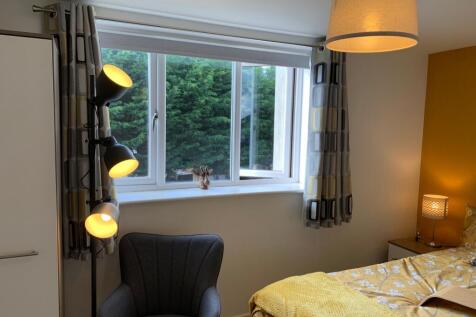 A cozy and well-lit double bedroom featuring a ...