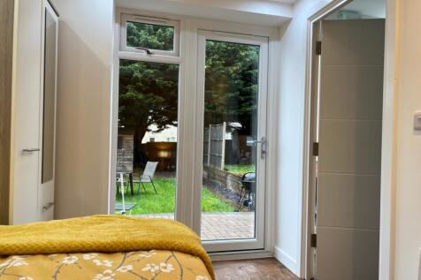 A bright and inviting double bedroom with a vie...