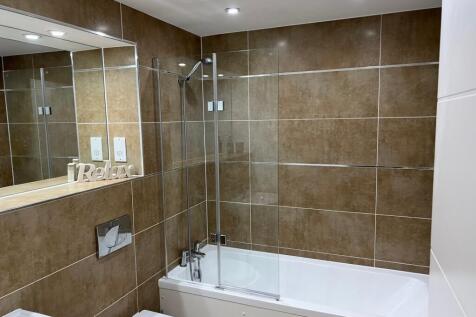 A beautifully designed large bathroom featuring...