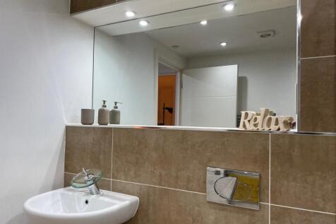 A modern and stylish bathroom featuring elegant...